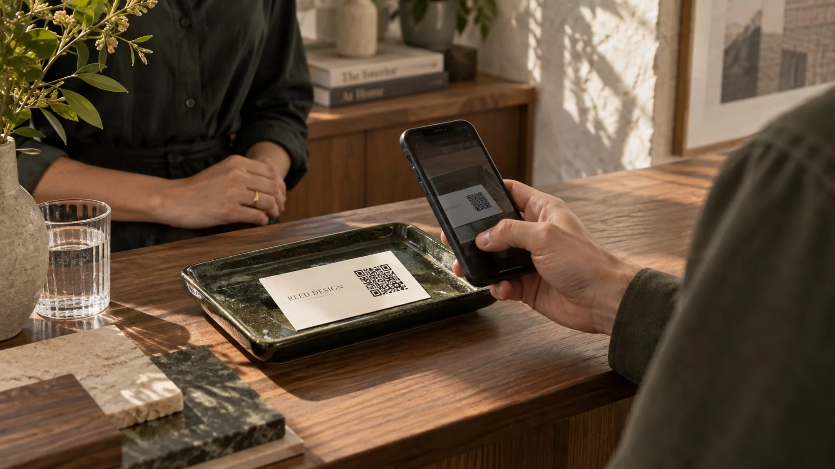 Scanning a business card at a design studio reception desk