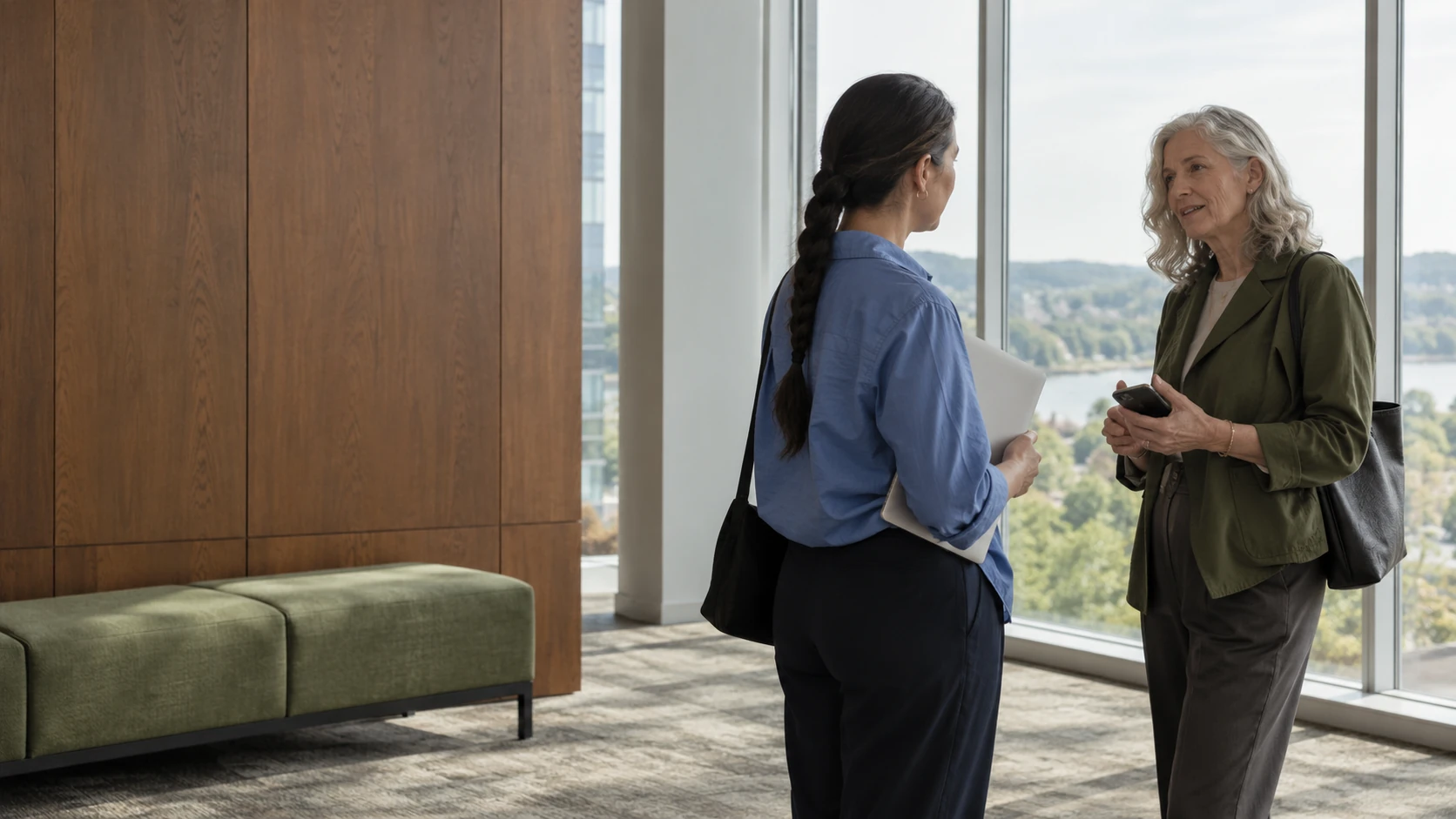 Two professionals connecting in a conference foyer